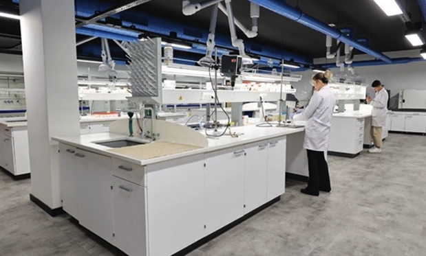 A spacious, modern laboratory with scientists working at various stations, showcasing Yiğitoğlu's advanced research and development facilities.