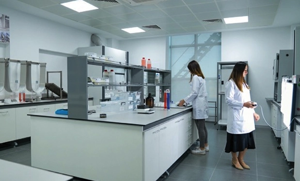 Scientists working in a clean and organized laboratory, highlighting Yiğitoğlu's commitment to innovation and quality control.